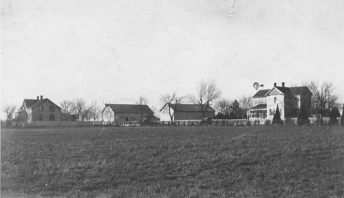 Bernhard Harder farm in 1915.  The house on the left was my great-grandparent's house built in 1877.  Great-grandfather's garden was to the left of the house.  The building third from the left is the <EM>Speicher</EM>, the first building constructed on the farm and the first worship center of the Emmaus Mennonite Church.  Grandfather's house, built in 1888 is on the right and Grandmother's kitchen garden was to the right of this house. Destroyed by a tornado in 1941.  Photographer unknown.  (Melvin Epp)