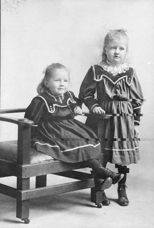 Granddaughters Marie (sitting) and Minna Harder as children enjoyed running through the garden.  Photo by Murphy, Newton, KS.  (Melvin Epp)